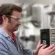 Technician verifying VFD parameter settings for motor current and overload